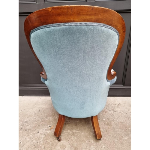 1082 - A Victorian mahogany and button upholstered occasional armchair. 