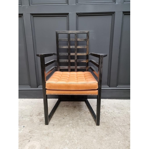 1083 - An ebonized and buttoned tan leather armchair, by Josef Hoffmann for Wittmann, (some worm).... 