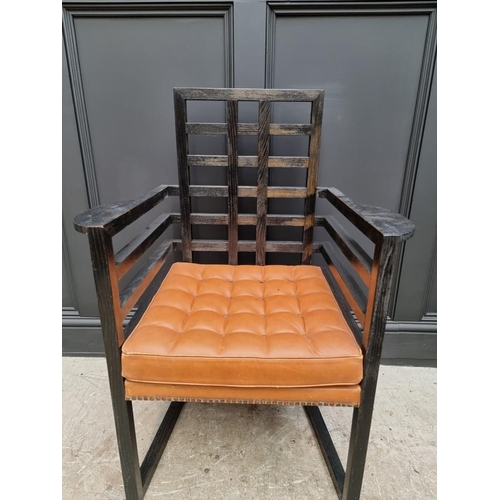 1083 - An ebonized and buttoned tan leather armchair, by Josef Hoffmann for Wittmann, (some worm).... 