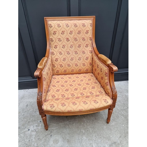 1085 - A Louis XVI style carved beech fauteuil. 