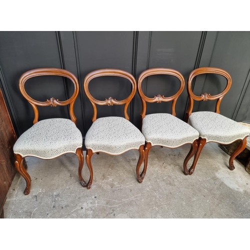 1087 - A set of four Victorian walnut balloon back dining chairs.  