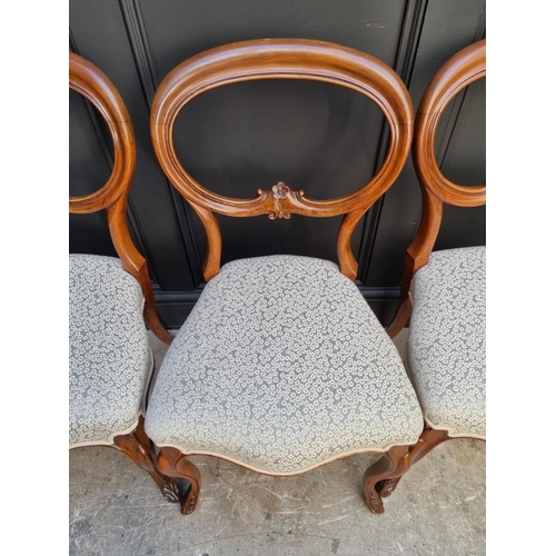 1087 - A set of four Victorian walnut balloon back dining chairs.  