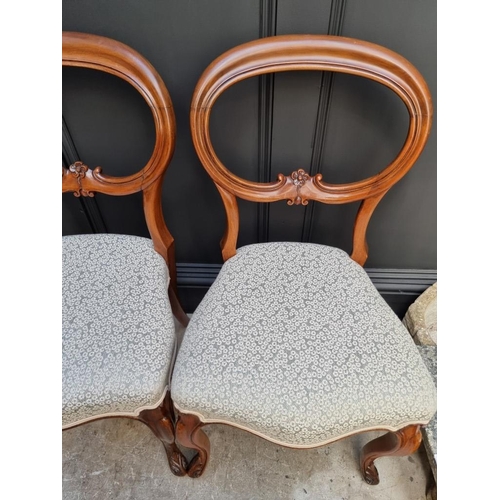 1087 - A set of four Victorian walnut balloon back dining chairs.  