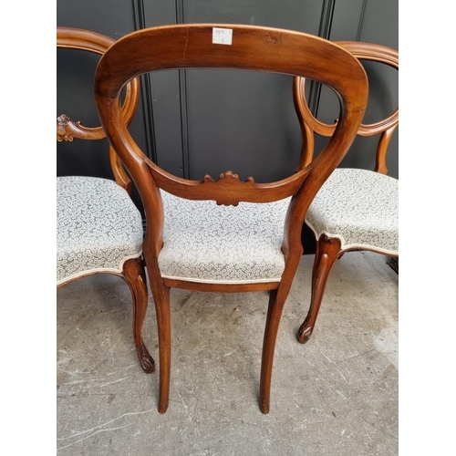 1087 - A set of four Victorian walnut balloon back dining chairs.  