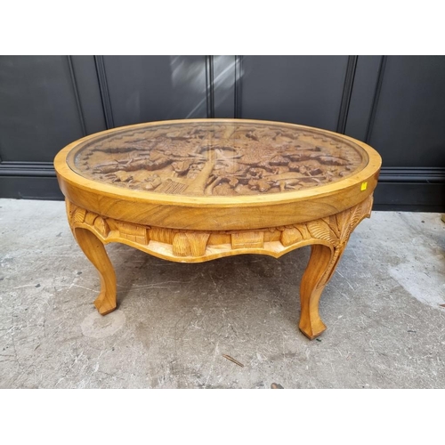 1091 - An Eastern carved hardwood circular low occasional table, 91cm diameter.