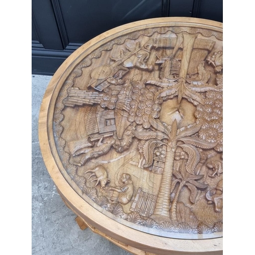 1091 - An Eastern carved hardwood circular low occasional table, 91cm diameter.