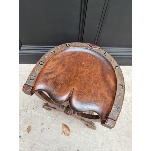 1093 - An unusual late Victorian mahogany novelty horseshoe stool, inscribed 'Good Luck'. ... 