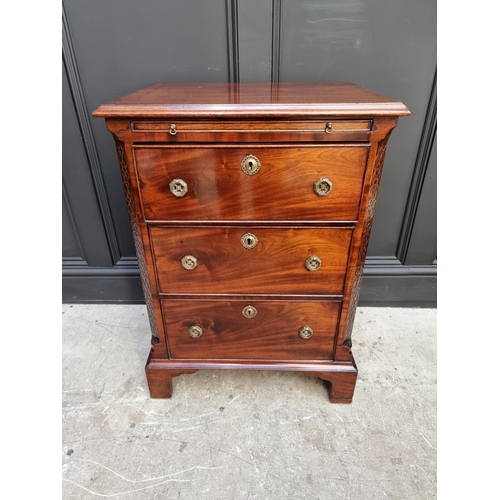 1097 - A small antique mahogany three drawer chest, with brushing slide, 57.5cm wide, (alterations).... 