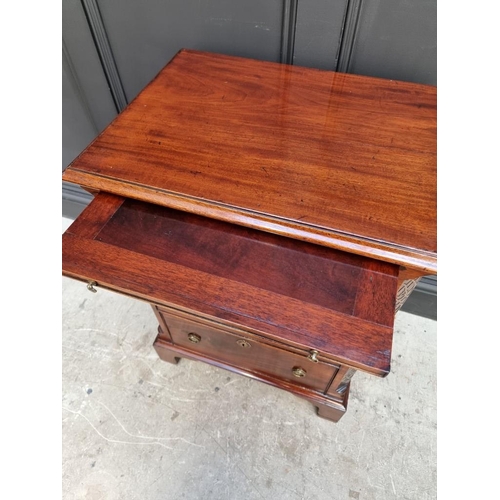 1097 - A small antique mahogany three drawer chest, with brushing slide, 57.5cm wide, (alterations).... 