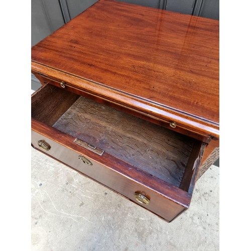 1097 - A small antique mahogany three drawer chest, with brushing slide, 57.5cm wide, (alterations).... 