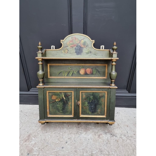 1102 - An antique green painted and parcel gilt hanging wall cabinet, painted with fruit, 61.5cm wide.... 