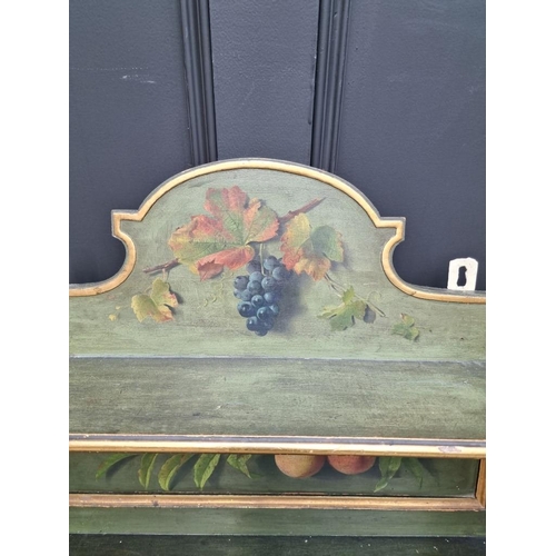 1102 - An antique green painted and parcel gilt hanging wall cabinet, painted with fruit, 61.5cm wide.... 