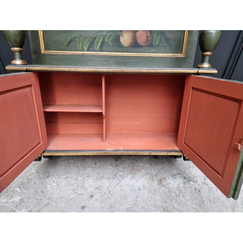 1102 - An antique green painted and parcel gilt hanging wall cabinet, painted with fruit, 61.5cm wide.... 