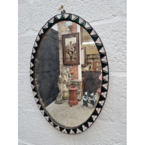 1107 - An Irish style oval wall mirror, 60.5 x 42.5cm.  