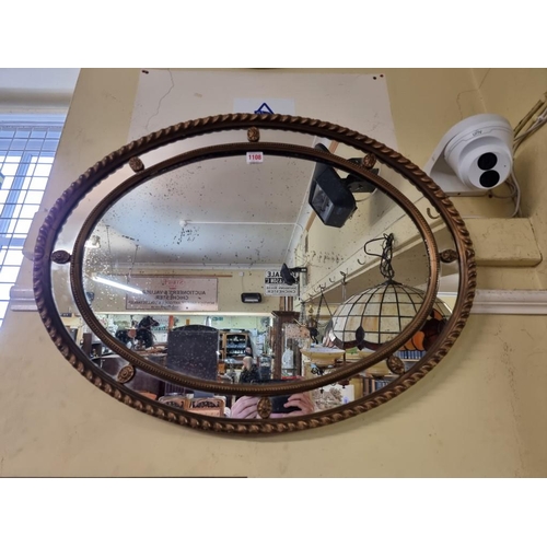 1108 - An antique giltwood frame oval wall mirror, 76.5 x 58cm.