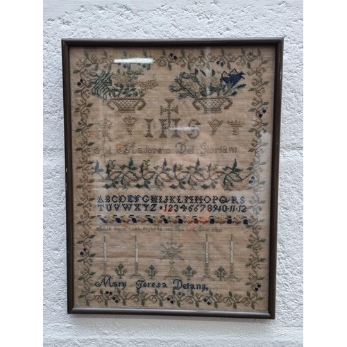 1146 - A 19th century needlework sampler, by 'Mary Teresa Delany', 32.5 x 24.5cm.  ... 