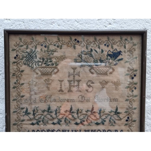 1146 - A 19th century needlework sampler, by 'Mary Teresa Delany', 32.5 x 24.5cm.  ... 