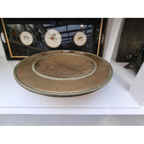 1249 - A Victorian brass pedestal dish, with engraved decoration, 32.5cm diameter.