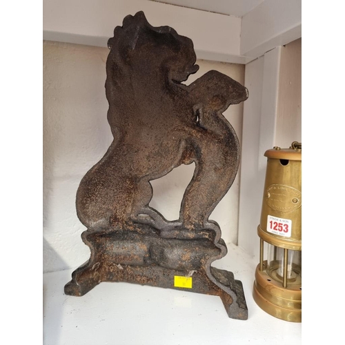 1257 - An antique cast iron lion door stop, 38cm high. 