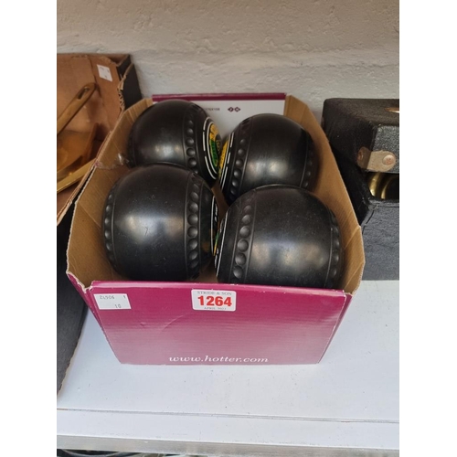 1264 - A set of four lawn bowls. 