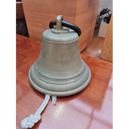 1266 - A bronze bell and wrought iron wall bracket, 20.5cm diameter. 