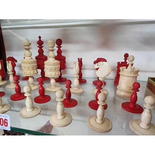 1306 - An antique bone chess set, red stained and natural, king 10.4cm, pawn 4.1cm.