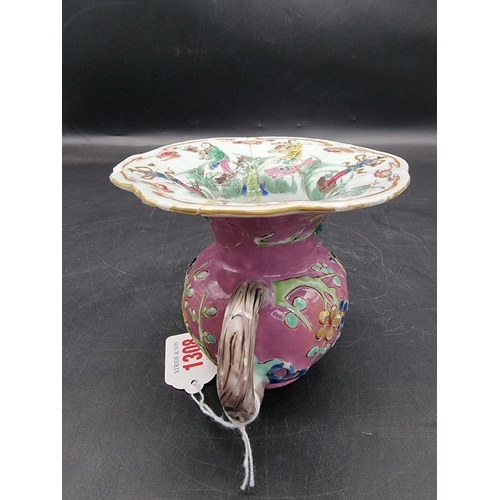 1308 - A Chinese famille rose pink ground spittoon, Yongzheng, with relief moulded decoration to the exteri... 