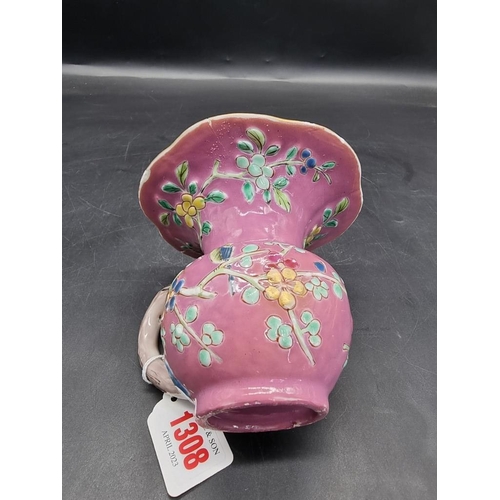 1308 - A Chinese famille rose pink ground spittoon, Yongzheng, with relief moulded decoration to the exteri... 