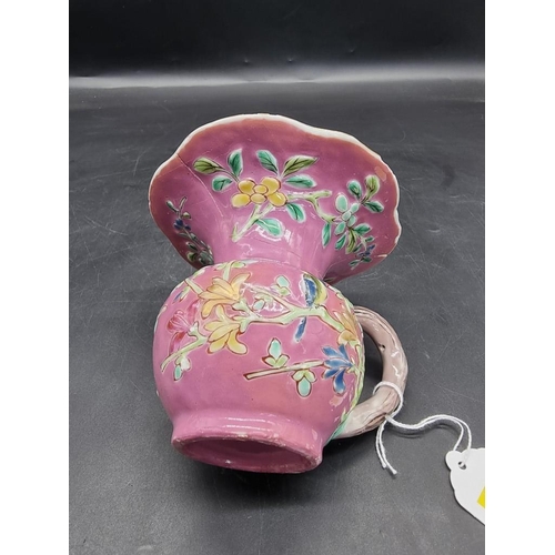 1308 - A Chinese famille rose pink ground spittoon, Yongzheng, with relief moulded decoration to the exteri... 