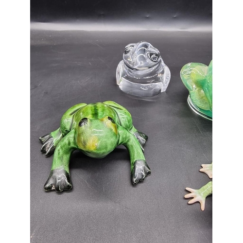 1312 - Seven frog models, to include: a Daum green glass example, 8.5cm high; an Orrefors clear glass examp... 