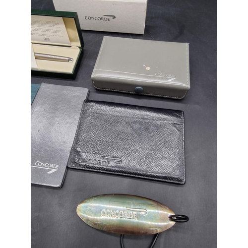 1314 - WITHDRAWN FROM AUCTION  A small group of Concorde items, to include: a luggage tag; leather wallet; ... 