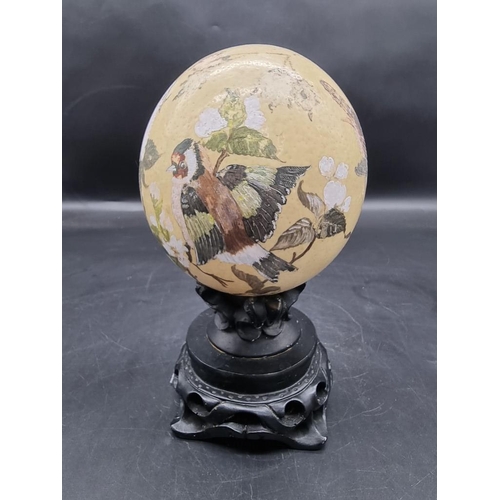 1315 - Natural History: a painted ostrich egg, decorated with garden birds, monogramed and dated 1981, on s... 