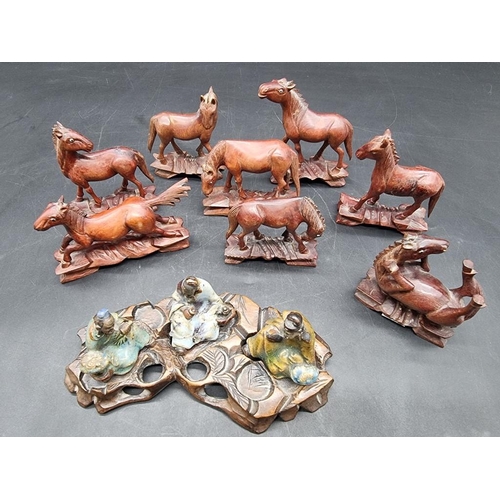 1317 - A set of eight carved wood horses of Mu Wang, each with inset eyes, largest 10.5cm wide; together wi... 