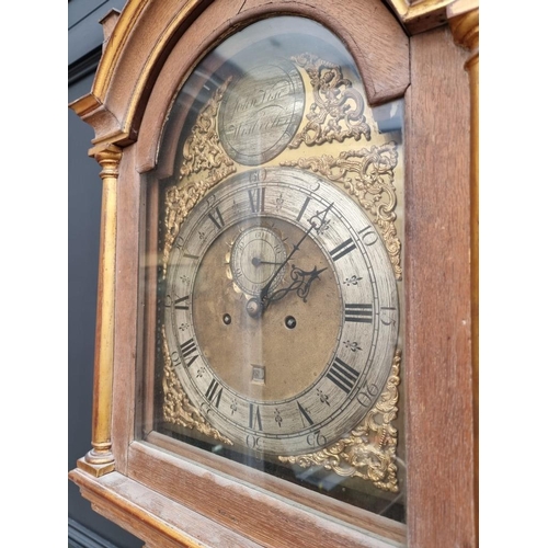 1335 - An 18th century oak, painted and parcel gilt 8 day longcase clock, the 11in arched brass dial inscri... 