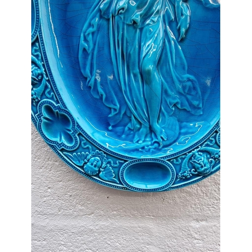 1337 - A Victorian Mintons majolica oval plaque, circa 1874, 51 x 39cm, (repaired).