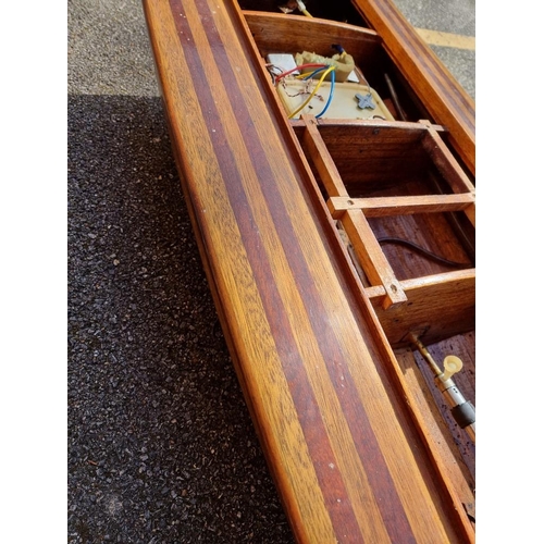 1373 - A large mahogany model launch or speedboat, with engine, 164cm long, on wood stand. ... 