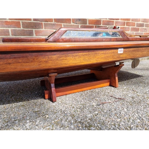 1373 - A large mahogany model launch or speedboat, with engine, 164cm long, on wood stand. ... 