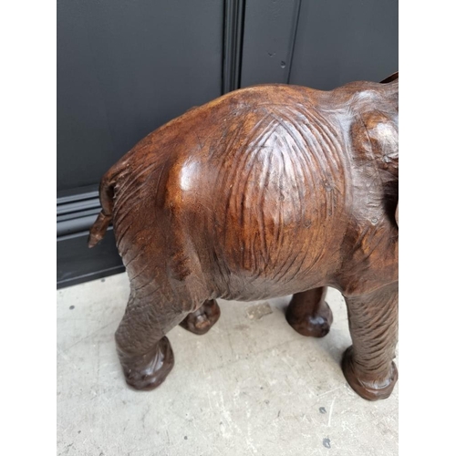 1383 - A large leather elephant, stamped 'Liberty X London', 74cm high. 