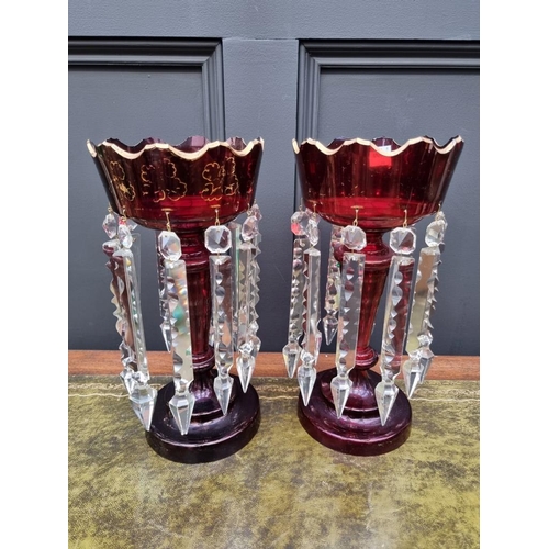 1384 - A pair of antique ruby glass lustres, 32cm high. 