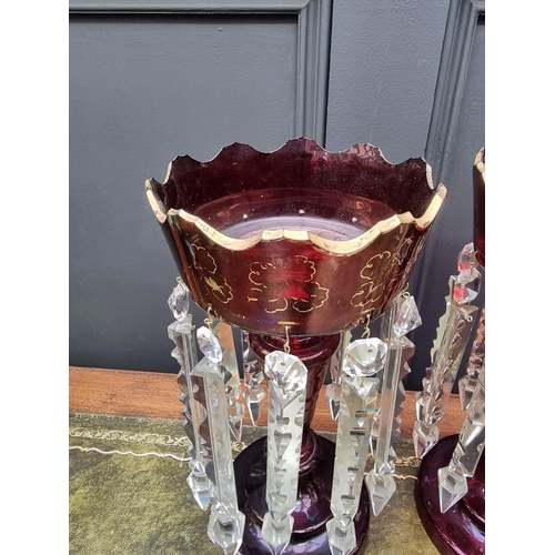 1384 - A pair of antique ruby glass lustres, 32cm high. 