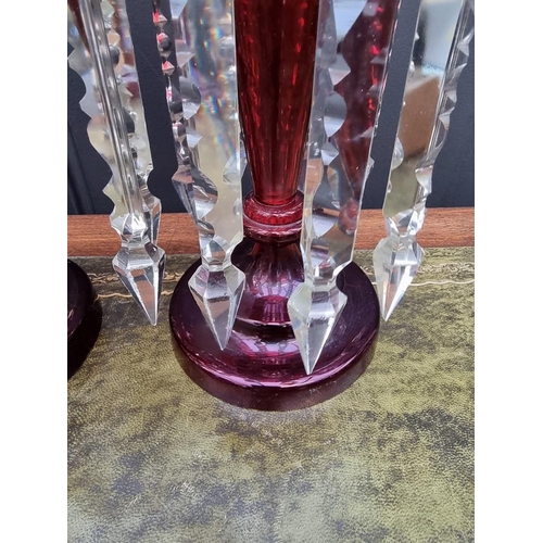 1384 - A pair of antique ruby glass lustres, 32cm high. 