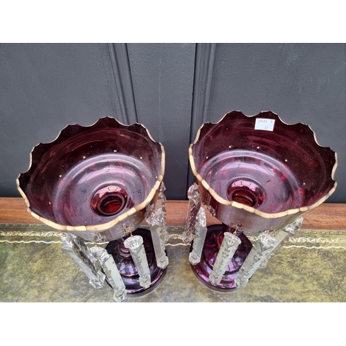 1384 - A pair of antique ruby glass lustres, 32cm high. 