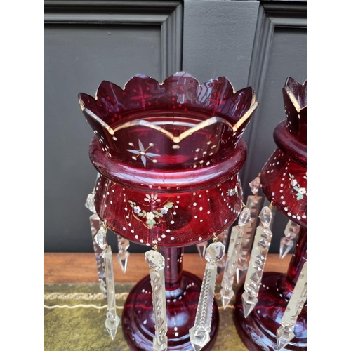 1387 - A pair of antique ruby glass lustres, 36cm high.