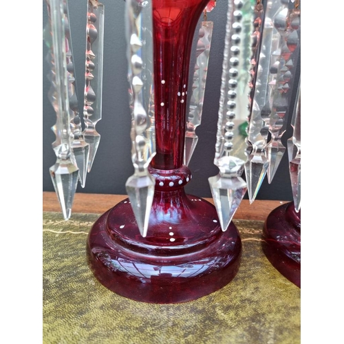 1387 - A pair of antique ruby glass lustres, 36cm high.