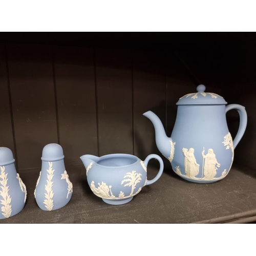 1401 - A Wedgwood pale blue jasperware part tea service, together with a matching pair of pepperettes.... 