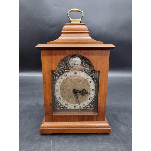 1411 - A reproduction walnut timepiece, 24.5cm high. 