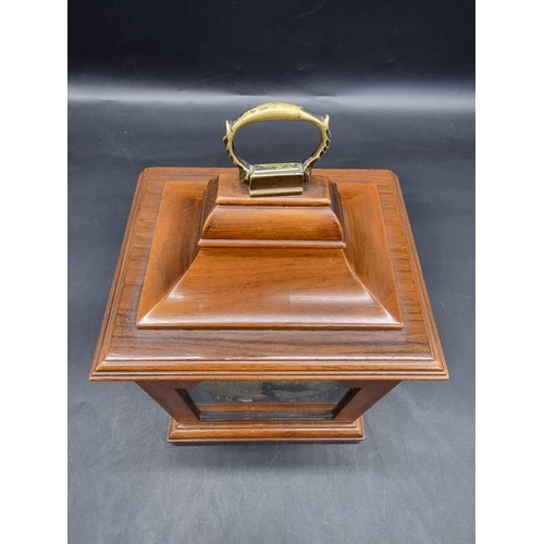 1411 - A reproduction walnut timepiece, 24.5cm high. 