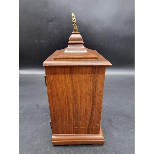 1411 - A reproduction walnut timepiece, 24.5cm high. 