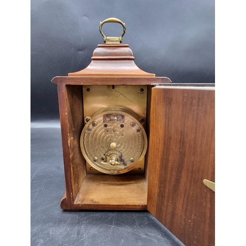 1411 - A reproduction walnut timepiece, 24.5cm high. 