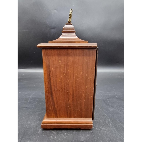 1411 - A reproduction walnut timepiece, 24.5cm high. 